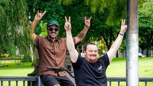 Gnargo co-founders Zach Springer and John Schoffner with their hands raised in a Portland park